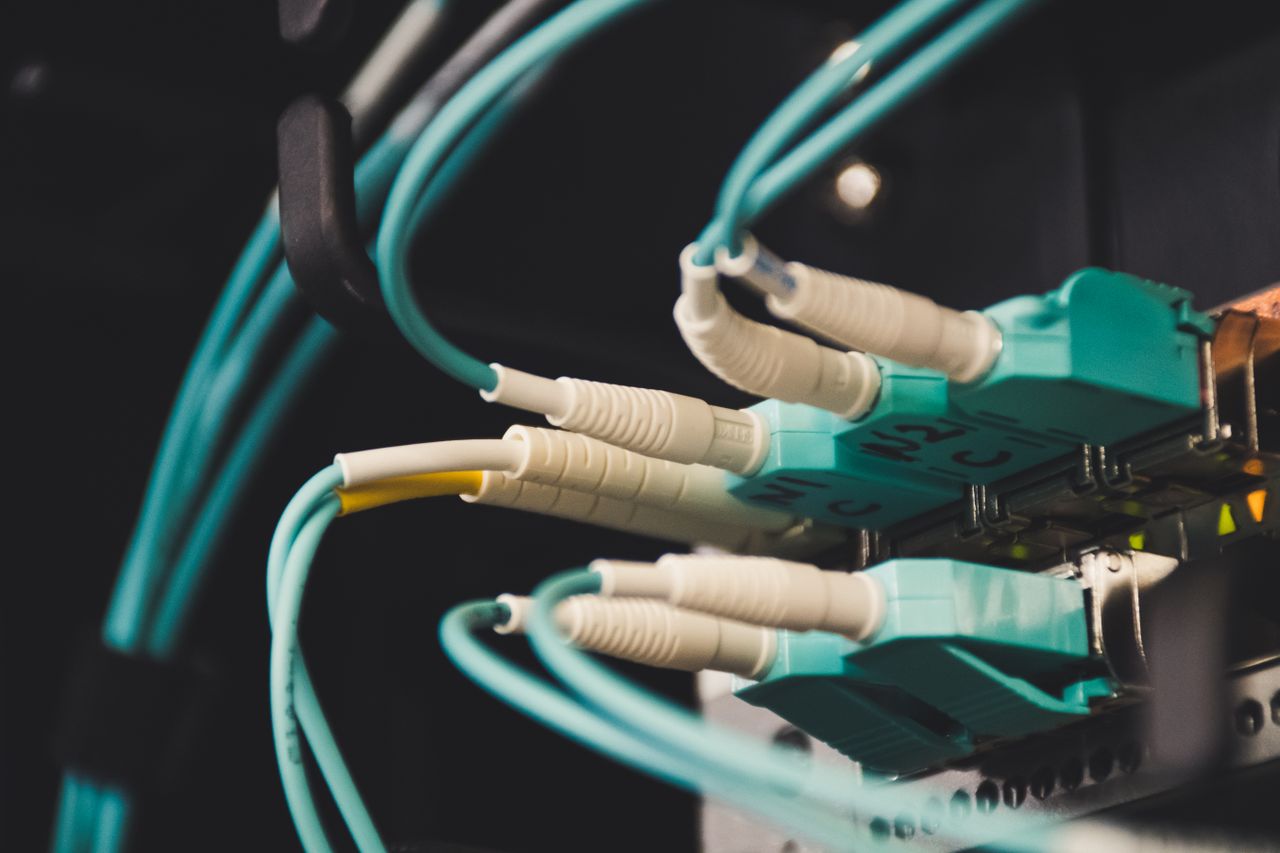 About Detailed view of fiber optic cables and ports in a server room, showcasing connectivity.