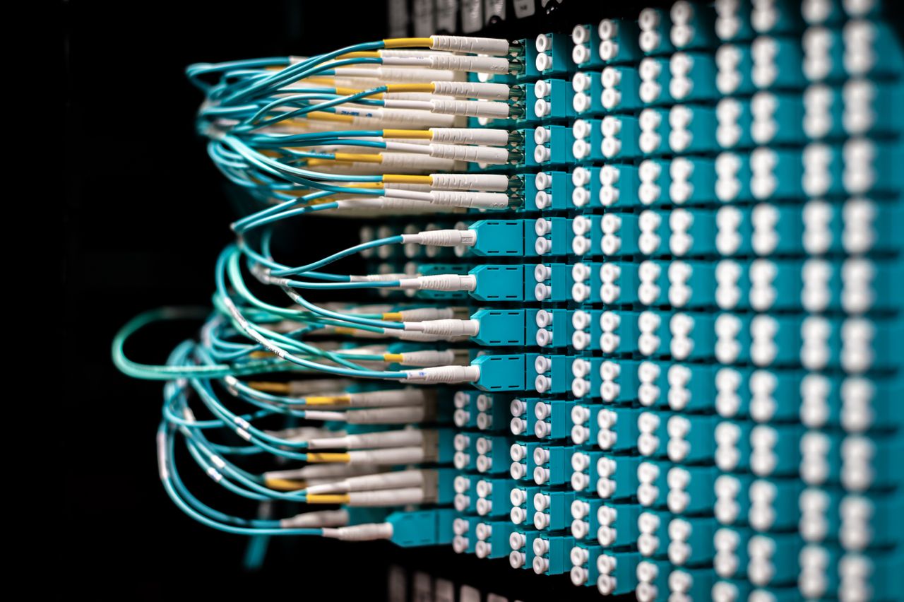 Services Server with electronic switches and connectors with yellow and green wires plugged in plastic device in operating room on black background