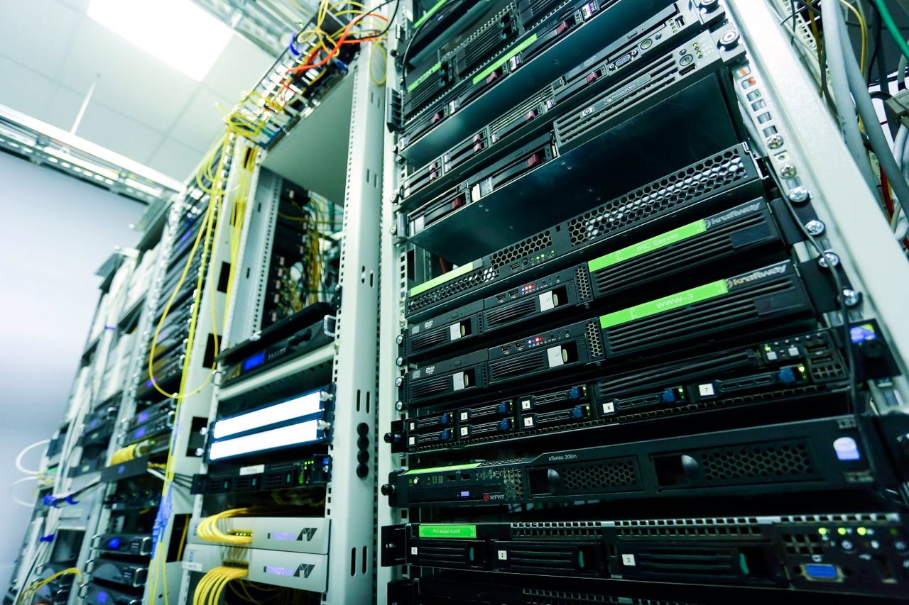 Services High-tech server rack in a secure data center with network cables and hardware components.